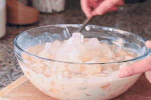 mixing in nata de coco for filipino fruit salad recipe