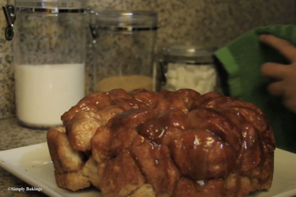 Monkey Bread drizzled with glaze on tray