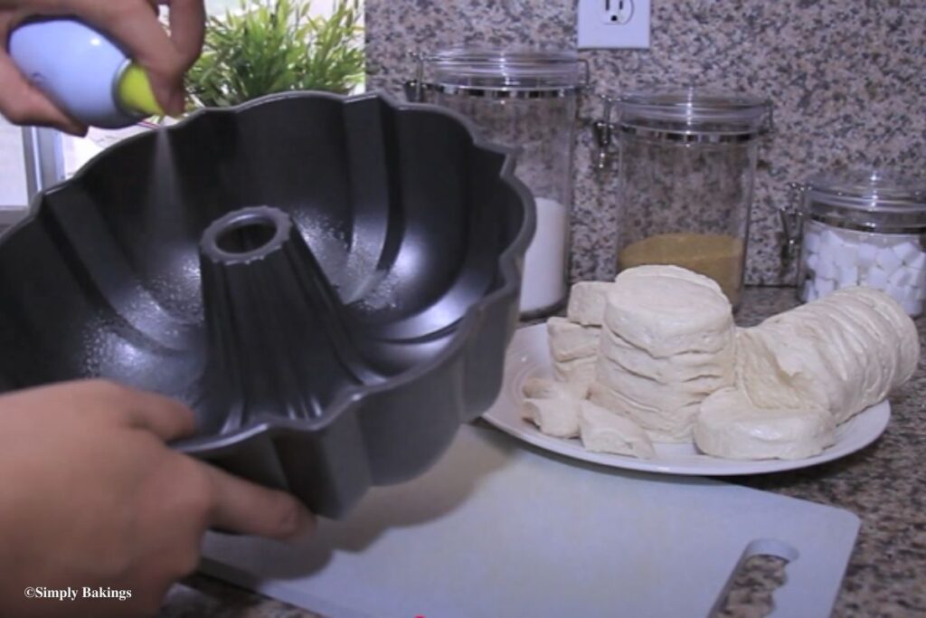Non stick spray aimed at Bundt pan next to plate