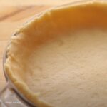 Golden, flaky sweet pie crust in a baking dish