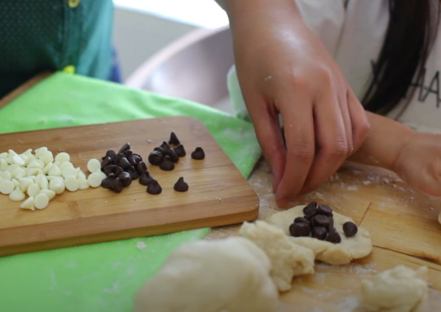 putting chocolate chips inside the dough