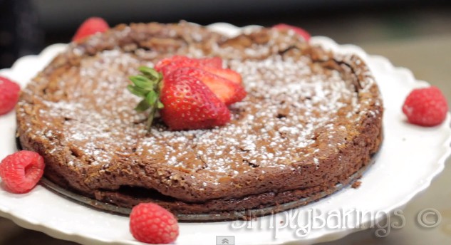 chocolate flourless cake garnished with fresh strawberries and raspberries