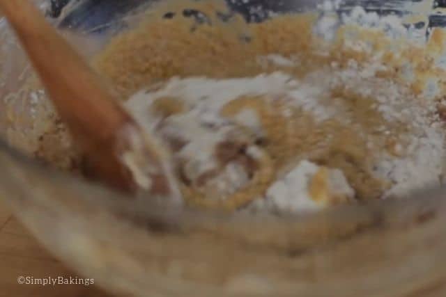 mixing the ingredients of the madeira cake with a wooden ladle