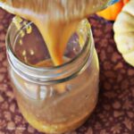 A cup of caramel sauce poured into a glass mug
