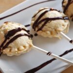 Homemade apple pie pops cooling on a plate