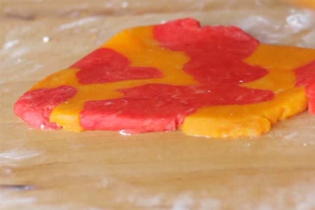 flattened colorful sugar leaf cookie dough on a wooden board