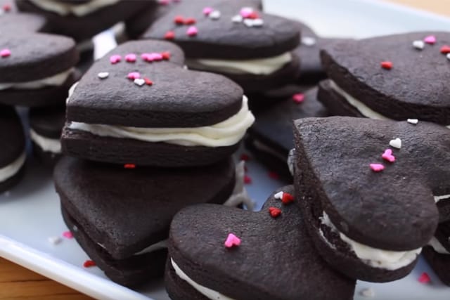 pretty oreo cookies with heart sprinkles on a plate