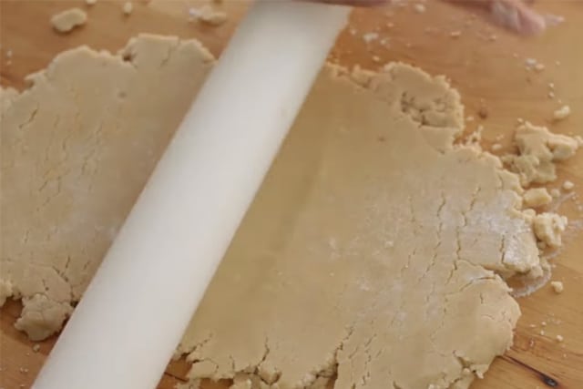 flattening the cookie dough using a rolling pin
