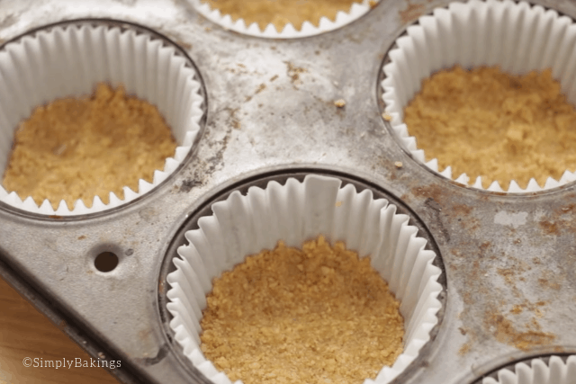 putting the graham crust into individual cupcake liners