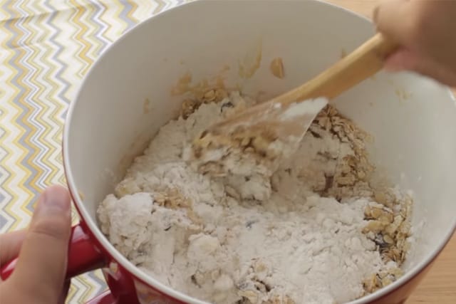 adding flour to the cookie batter