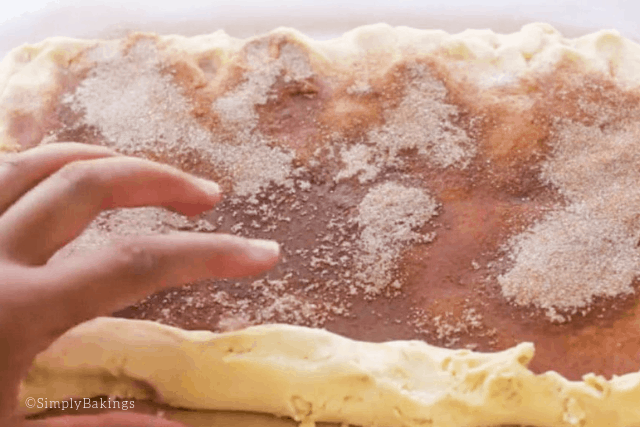 rolling cinnabon cookie dough into a log