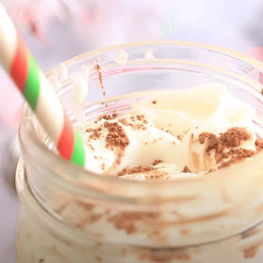 jar with whipped cram and cinnamon powder inside
