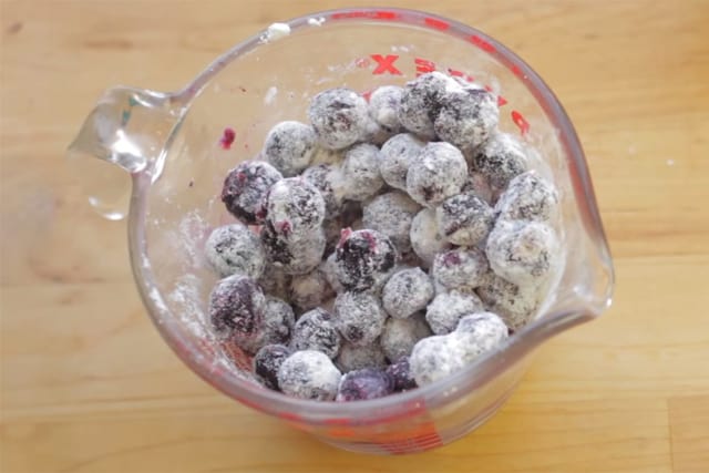 coating the fresh blueberries with flour