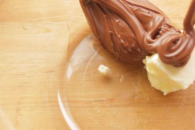 mixing the nutella and butter in a glass bowl