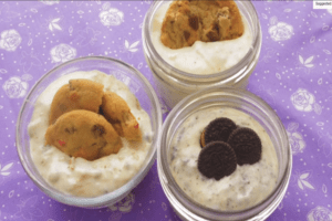 no bake cheesecakes in three mason jars topped with cookies