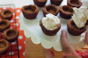 topping the cookie cups with whipped cream