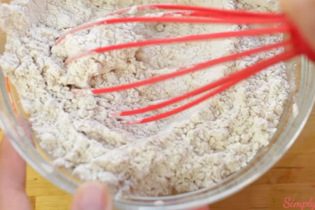 mixing the dry ingredients of the Sweet Potato cookies recipe using a wire whisk