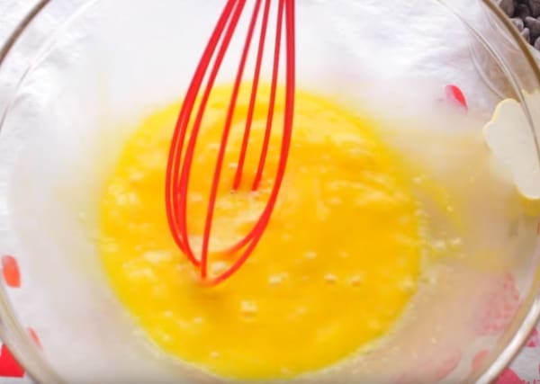 whisking the eggs in a bowl to be used for 3 ingredient cupcake recipe