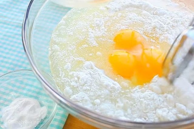 mixing the eggs and oil to the dry ingredients using a handheld mixer