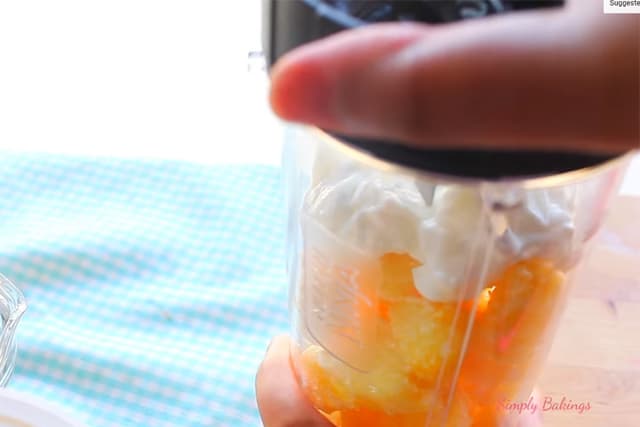 putting ingredients of pineapple ice cream in a blender