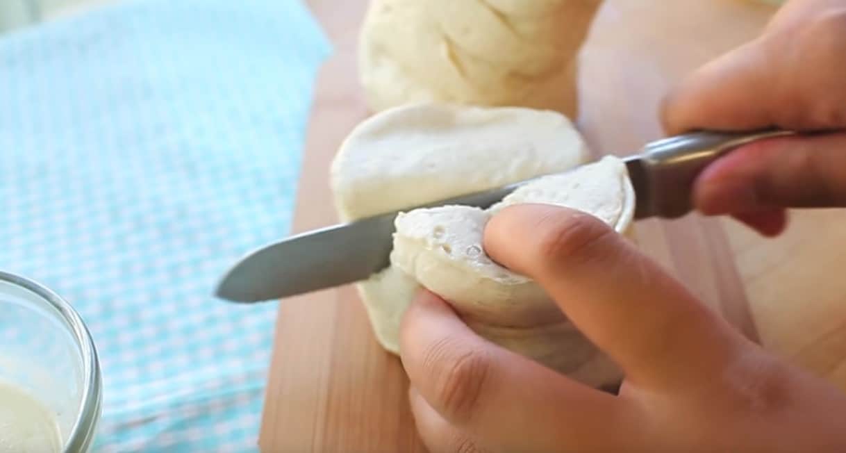 cutting the dough for Quick & Easy Cinnamon Roll Bites recipe