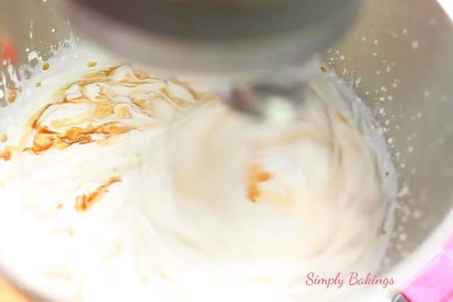 adding in the vanilla extract to the whipped cream