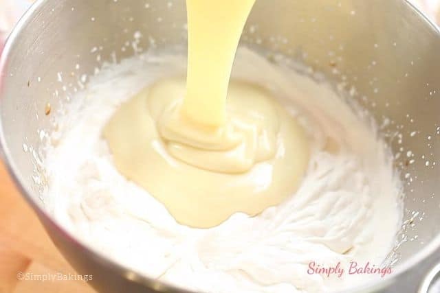 adding in the condensed milk to the whipped cream