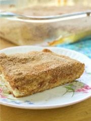 A white plate with churro cheesecake slice