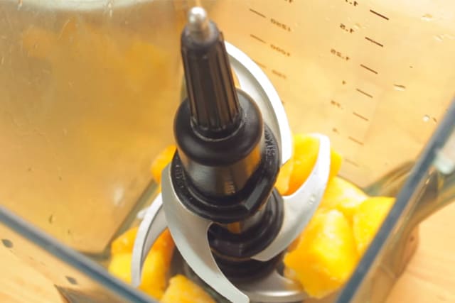 frozen mango cubes in a blender
