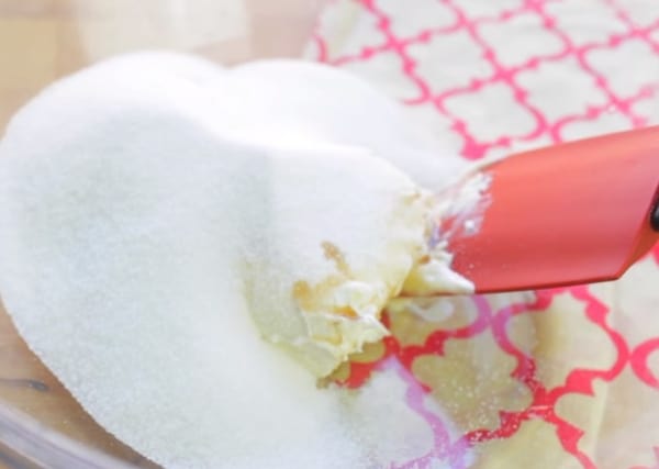 granulated sugar, butter, vanilla extract, and red spatula in a bowl for strawberry shortcake cookie recipe