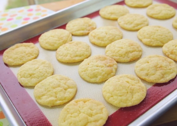 freshly baked vegan dairy free snickerdoodle cookies on a baking tray