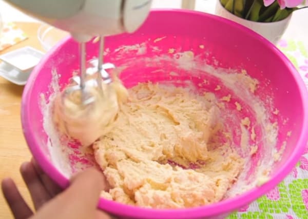 mixing vegan dairy free snickerdoodle cookie dough on a mixing bowl