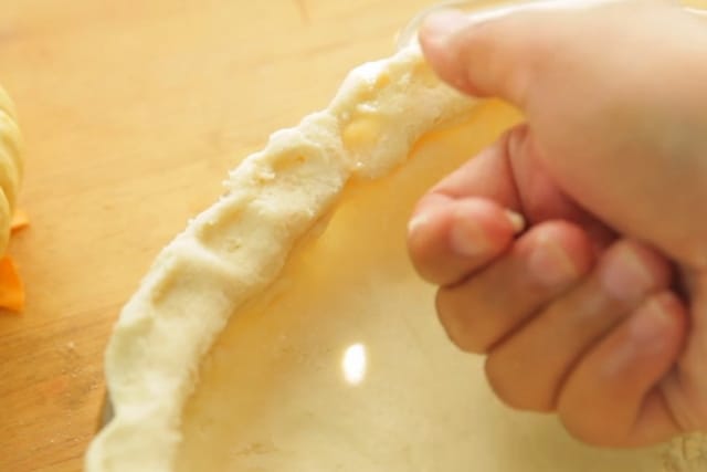 designing the crust of vegan pumpkin pie recipe using a thumb