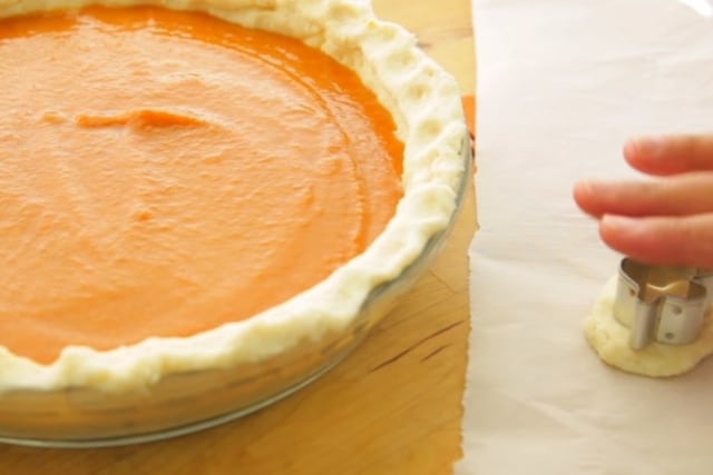 cutting dough with a leaf cookie cutter and the ready to bake vegan pumpkin pie