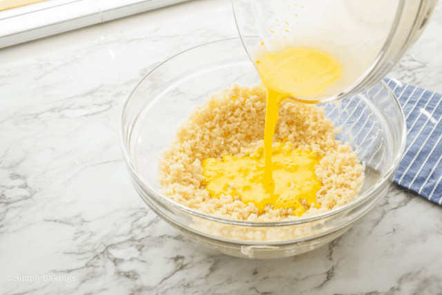 adding the wet ingredients to the flour mixture in a mixing bowl