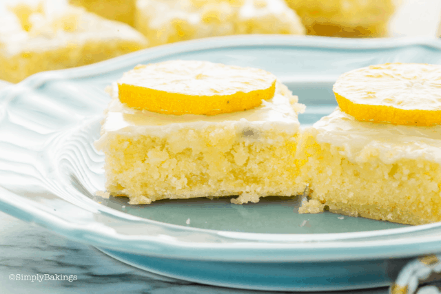 two slices of freshly baked lemon brownies topped with lemon slices