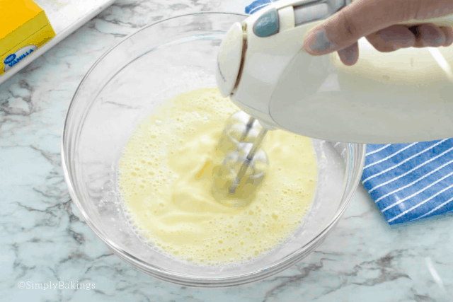 mixing the cold milk and banana pudding mix with a hand mixer