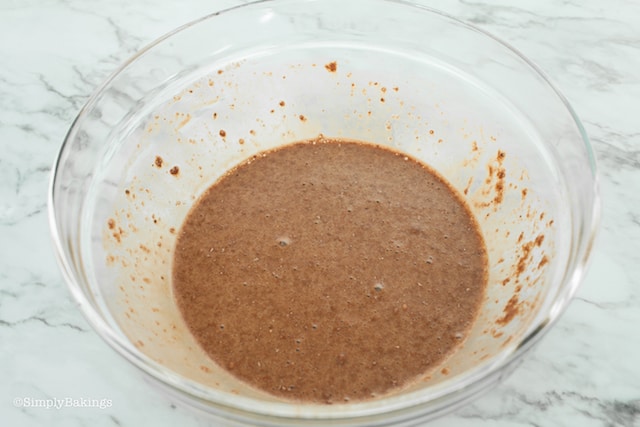 thoroughly mixed batter of chocolate mug cake with protein on a clear bowl