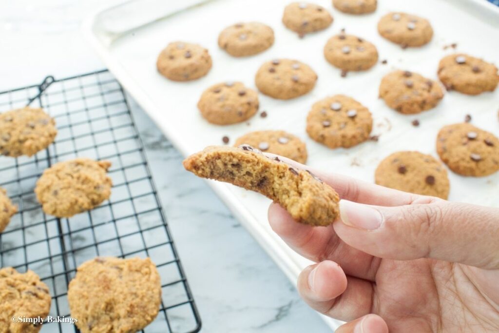 A cookie held up and bit on one side