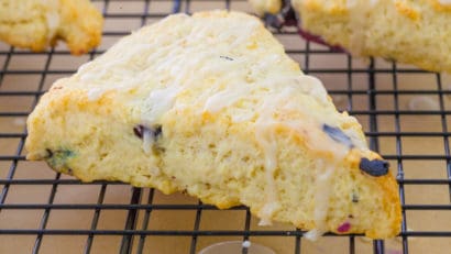 a slice of blueberry scones on a cooling rack