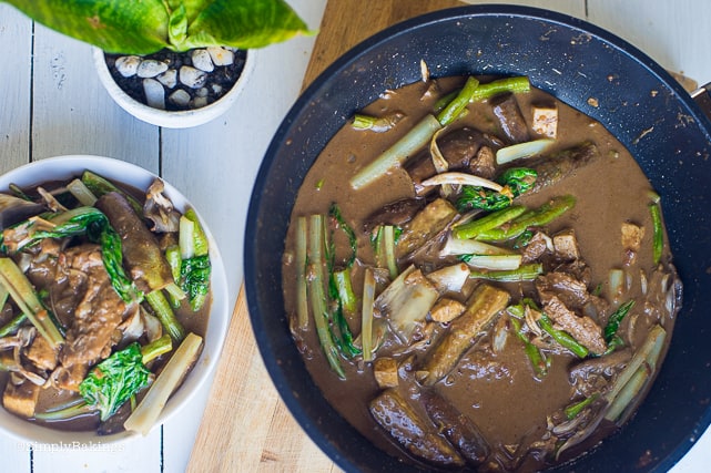 delicious and easy to cook vegan kare kare in a white bowl and saucepan