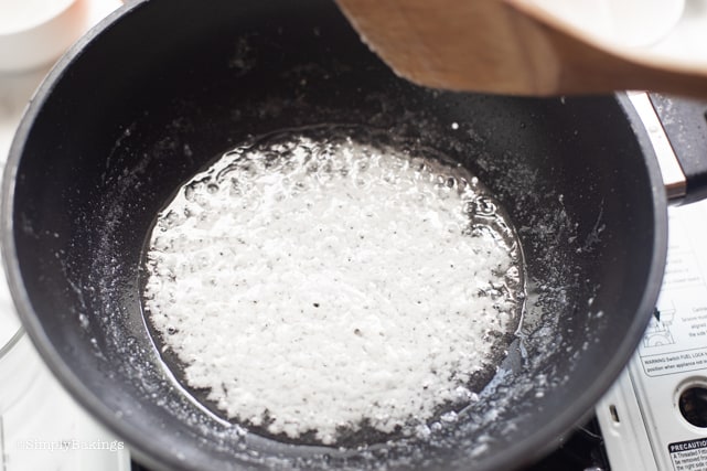 cooking latik using coconut milk in a pan