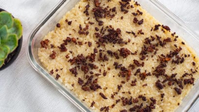 freshly cooked biko with latik in a glass tray