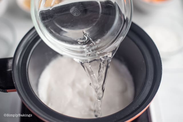 adding water to the boiling coconut milk for binignit recipe