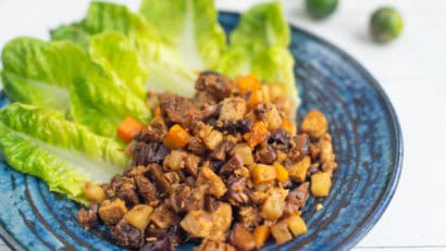 delicious vegan bopis served in a blue plate with lettuce leaves