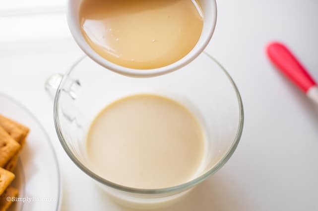adding condensed milk to the cream for the Mango Float recipe
