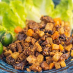 healthy and delicious Filipino vegan bopis served on a blue plate with lettuce leaves
