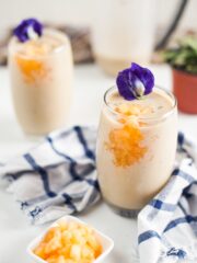 Two smoothies in glasses with flower on top