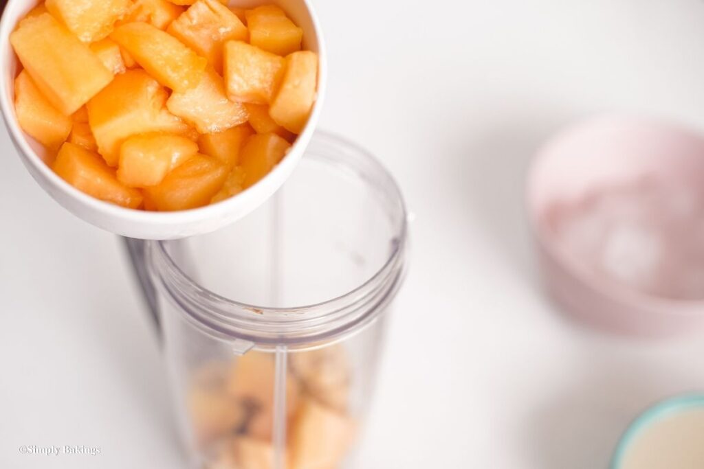 Cubes of fruit poured into a blender