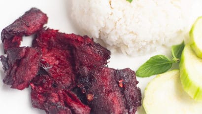 Vegan Tocino on a white plate with rice and cucumber slices